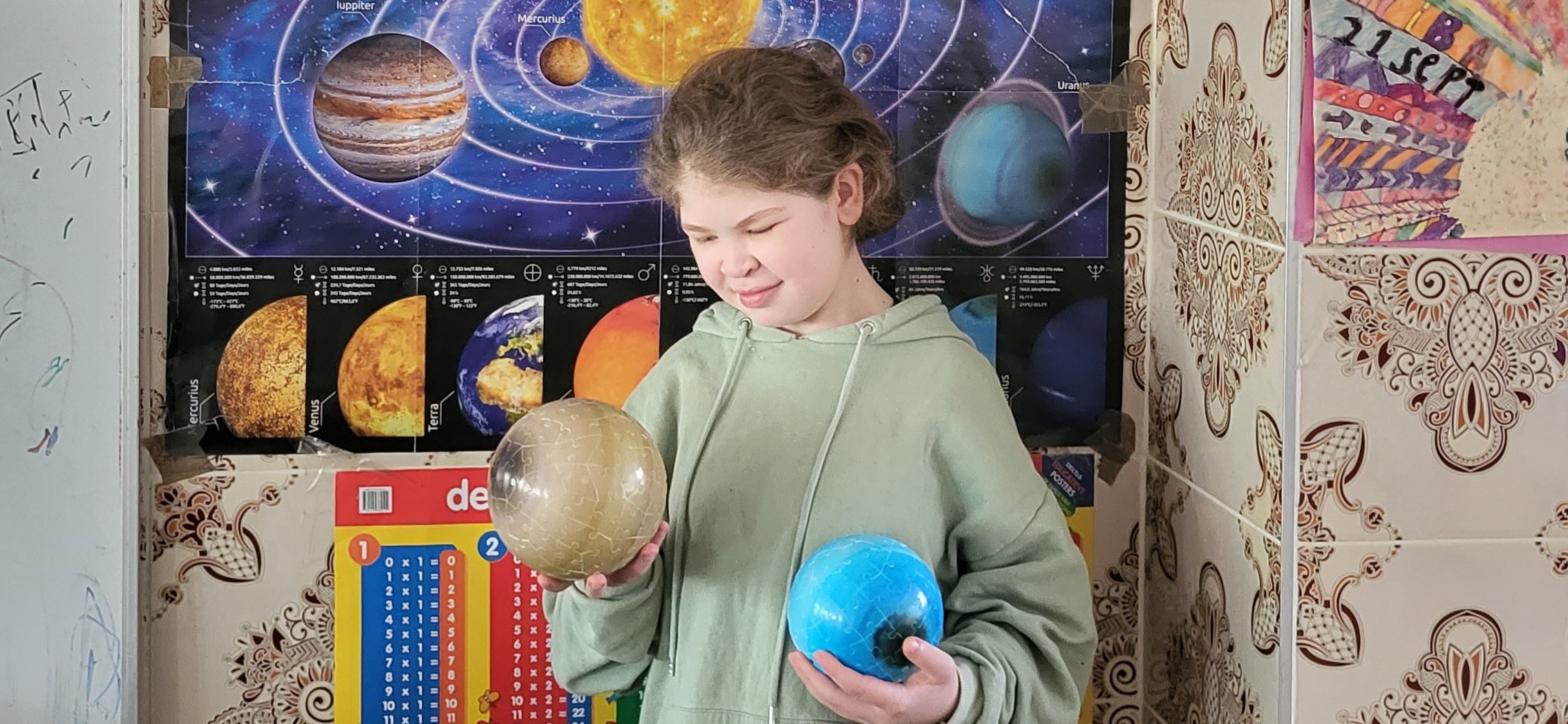 Foto van Hiba (14 jaar) voor poster met planeten en het heelal daarop afgebeeld